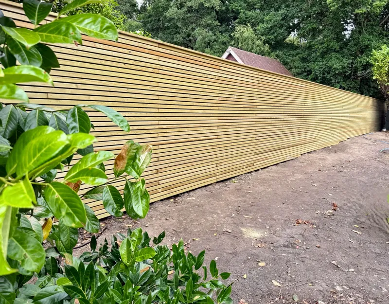 Long run of horizontal slatted fencing