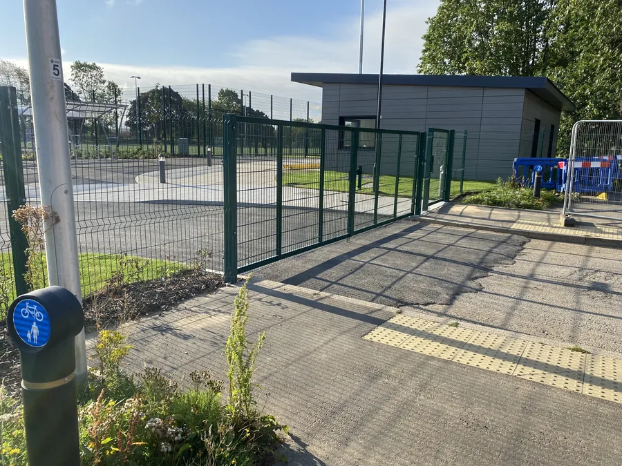Green mesh pedestrian and double access gates at the school boundary