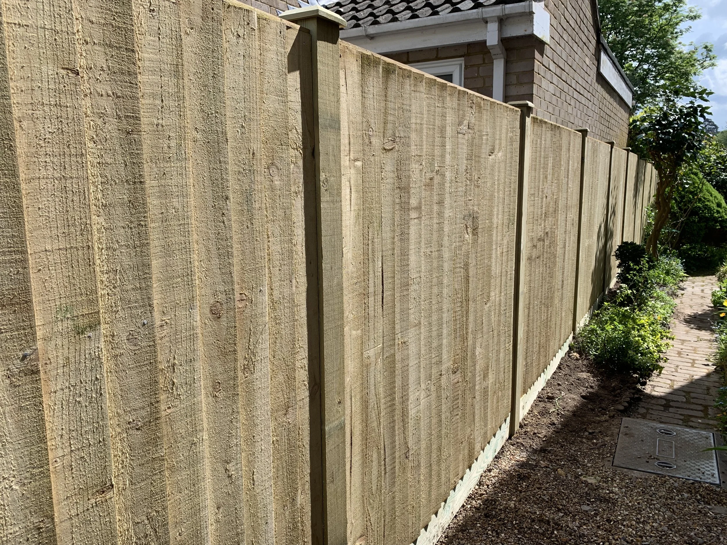 New wooden privacy fence along a driveway in Farnham