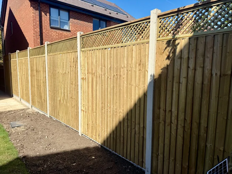 Timber garden fencing with lattice trellis and concrete posts